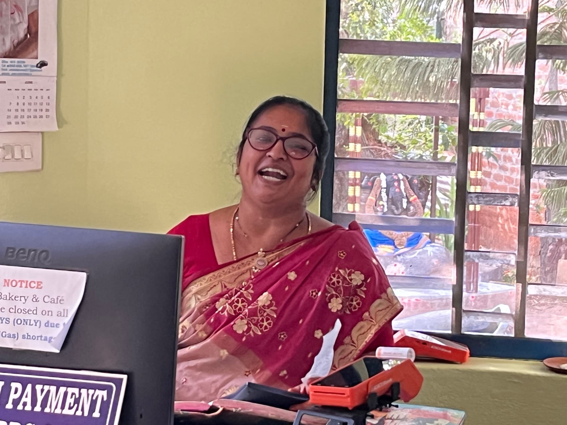 woman in red sari and glasses