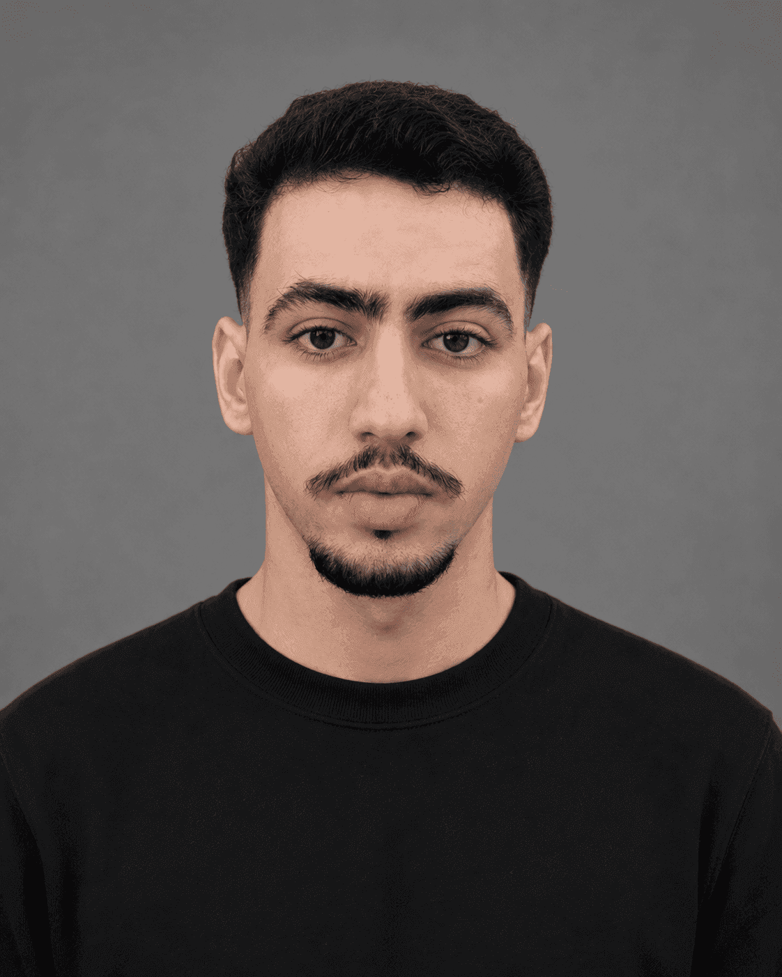 young man with dark hair and mustache