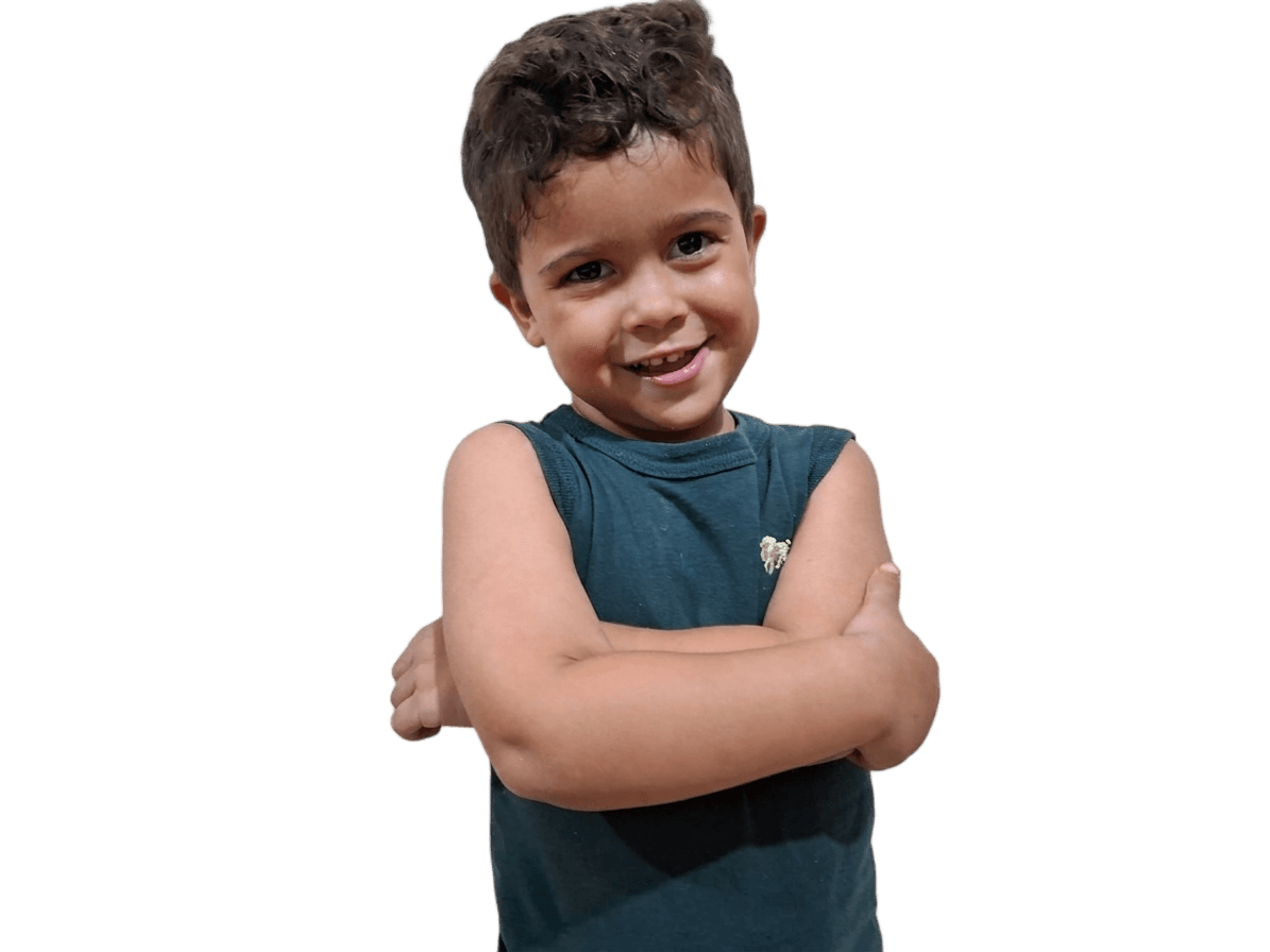 smiling young boy with crossed arms